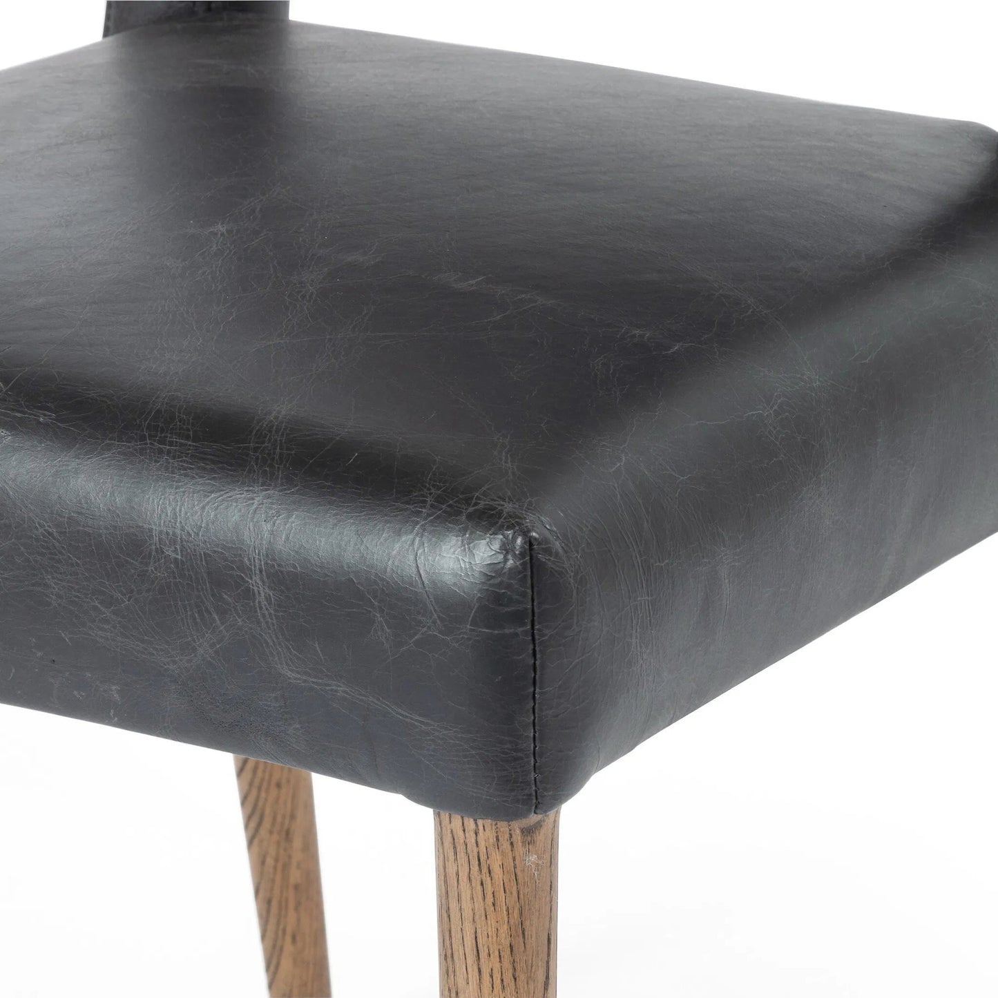 005 SI-2462029 | Closeup | Joseph Dining Chair by Four Hands in durango smoke, toasted oak. Made from top grain leather, solid oak in a traditional style.