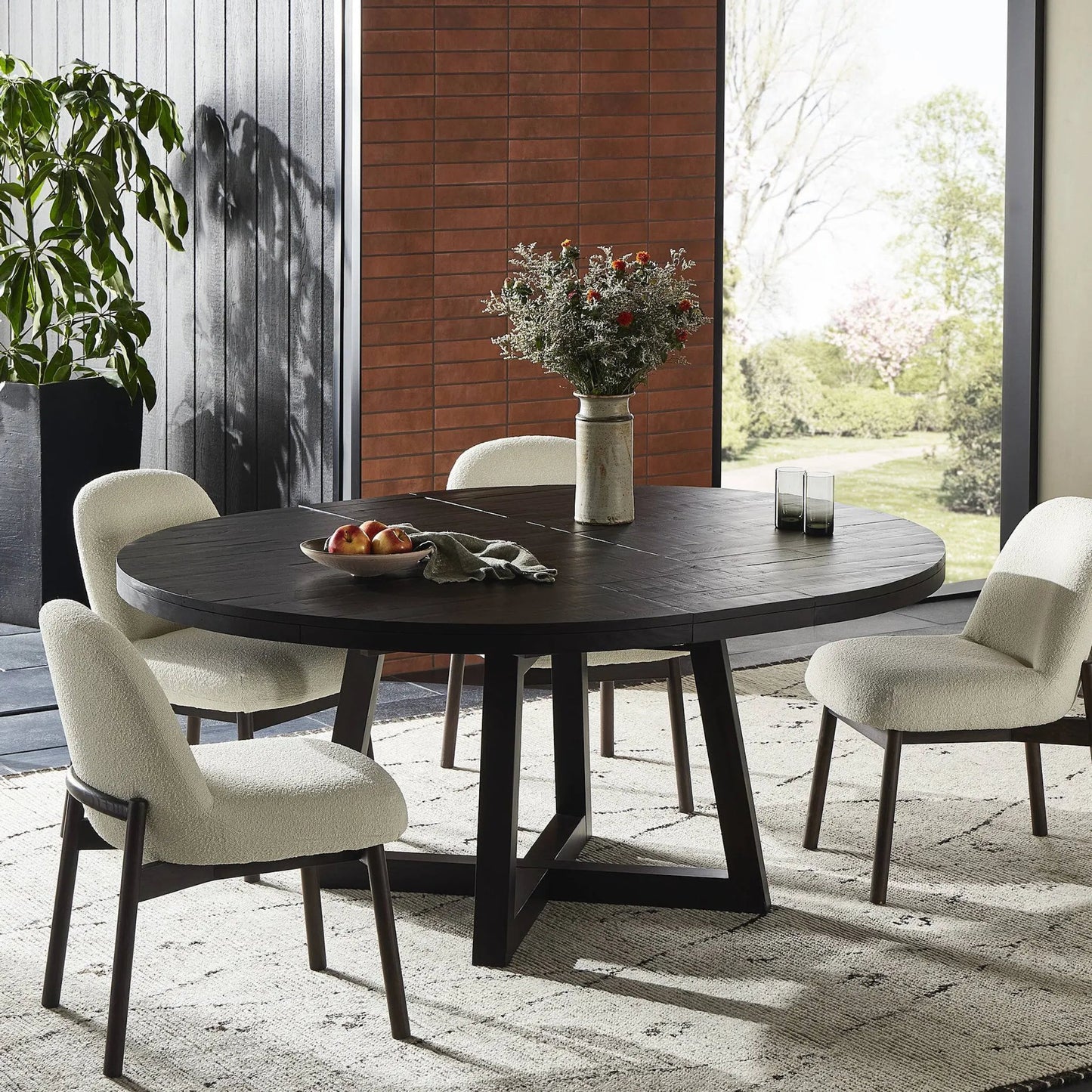 015 SI-2158148 | Lifestyle | Eberwin Round Ext Dining Table by Four Hands in dark carbon. Made from solid reclaimed pine in a modern style.