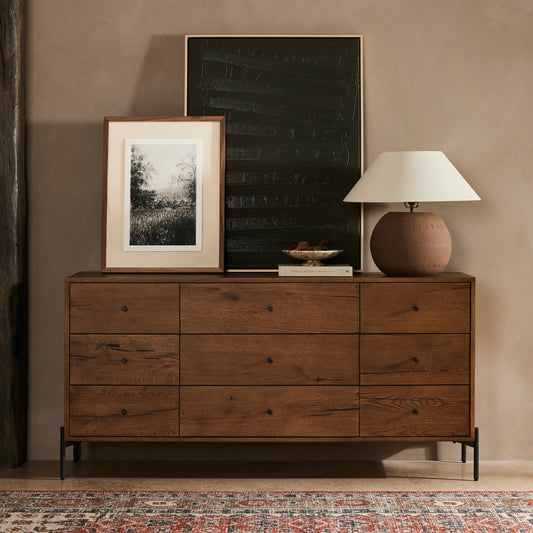 Eaton 9 Drawer Dresser by Four Hands in amber oak resin. Made from thick oak veneer, iron in a rustic style.