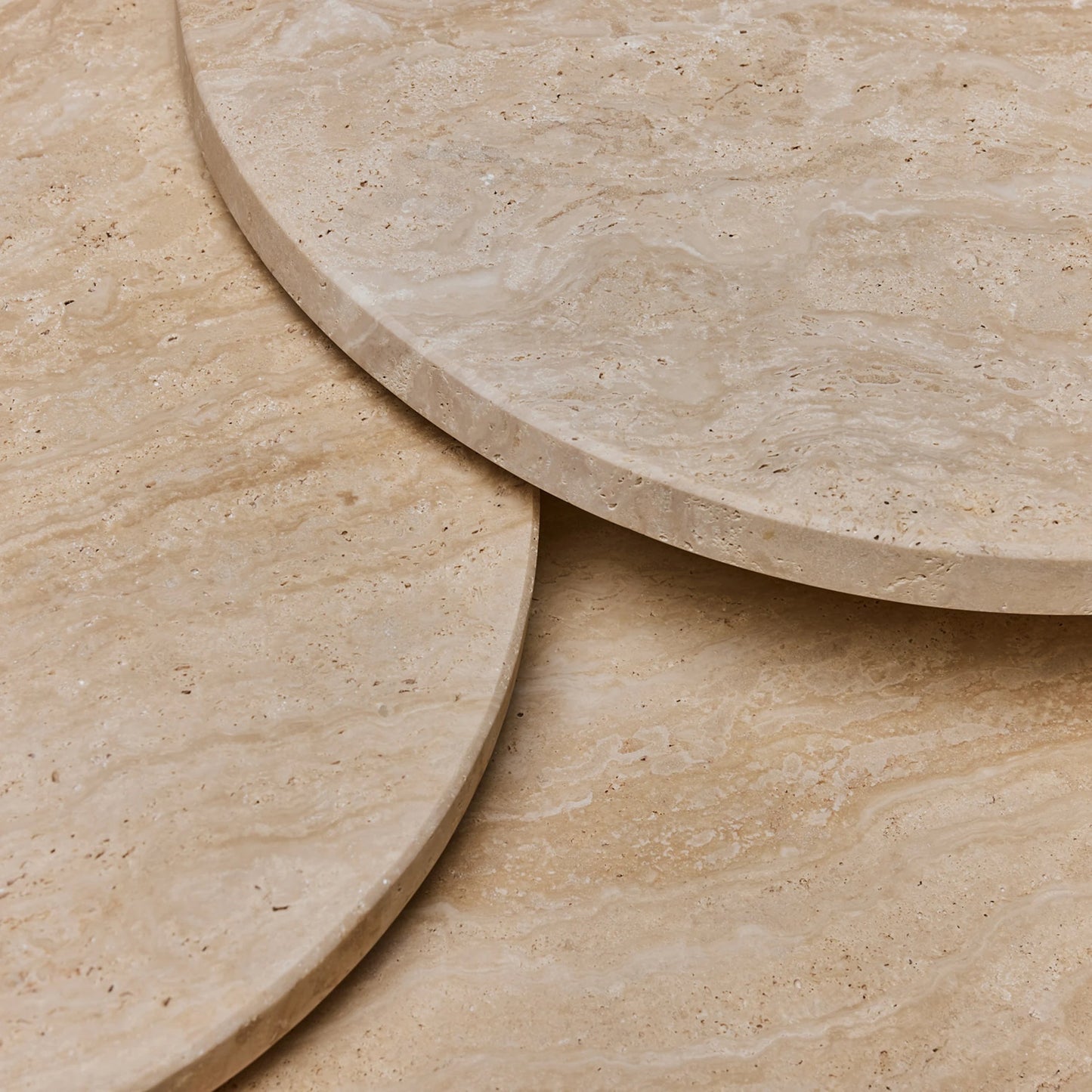004 SI-2122621 | Closeup | Amerigo Bunching Tables by Interlude Home in raw travertine. Made from travertine in a modern style.