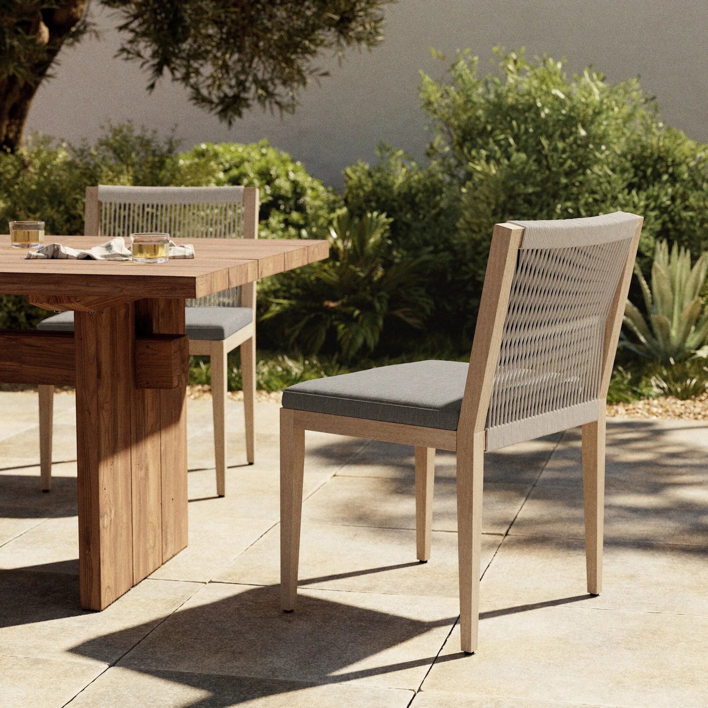 023 SR-810013 | Lifestyle | Sherwood Outdoor Dining Chair, Washed Brown by Four Hands in washed brown. Made from 100% olefin, solid fsc®-certified teak, 100% polypropylene in a cottage & farmhouse style.