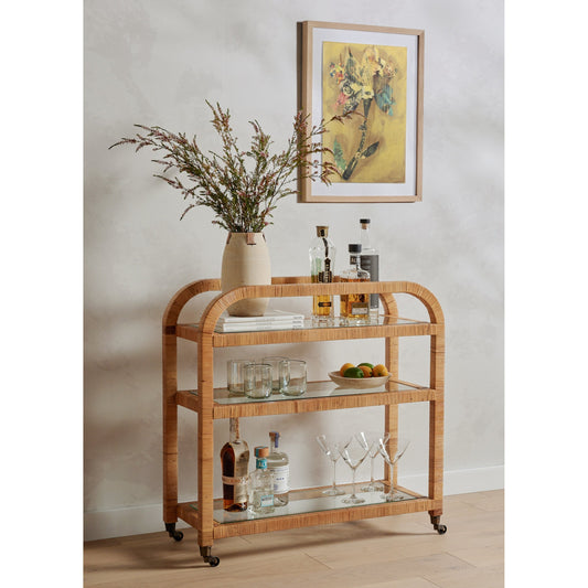 Dory Bar Cart by Four Hands in honey. Made from rattan, tempered glass, solid mahogany in a modern style.