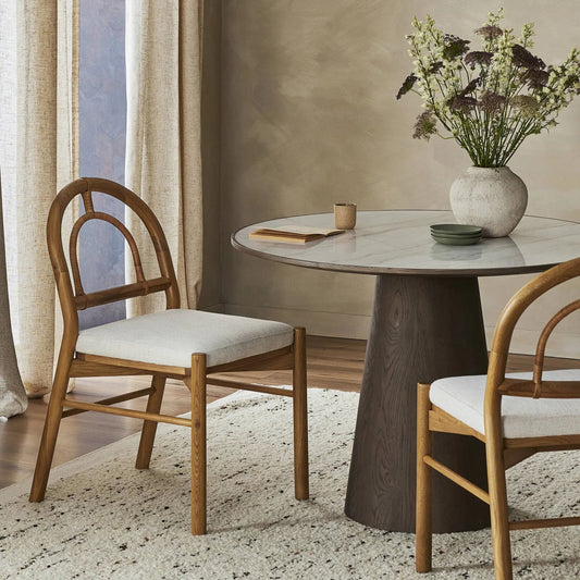 Pace Dining Chair by Four Hands in natural cane, dover crescent and burnished oak. Made from 71% viscose (rayon), 17% polyester, 12% flax, linen, solid oak, cane in a coastal style.