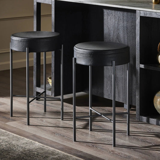Nocona Bar + Counter Stool by Four Hands in black leather, gunmetal and black leather. Made from top grain leather, iron, 100% polyurethane foam pad in a modern style.