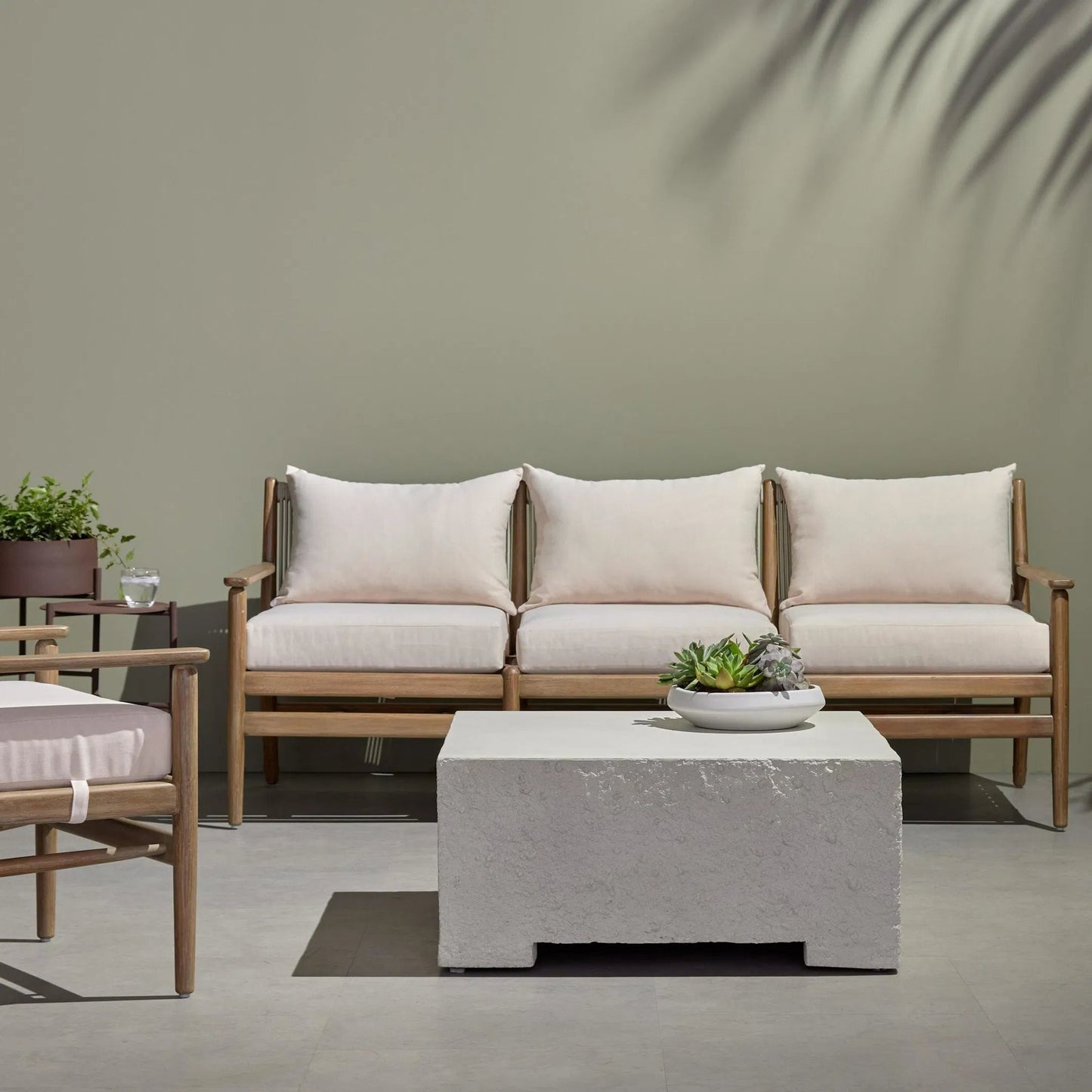 009 SI-1716336 | Lifestyle | Otero Outdoor Small Coffee Table by Four Hands in matte stone, blanc stone. Made from concrete in a modern style.