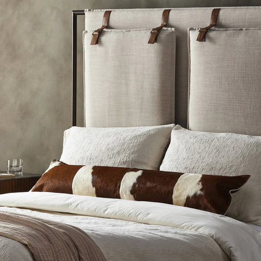 Modern Cowhide Lumbar Pillow by Four Hands in brown, white hair on hide, ivory backing. Made from hair on hide, 100% cotton, down alternative fiber in a unique style.