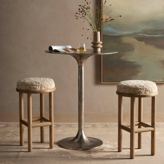 Saldino Counter Stool by Four Hands in blonde nettlewood, beige shearling. Made from shearling, solid nettlewood, 100% polyester in a transitional style.