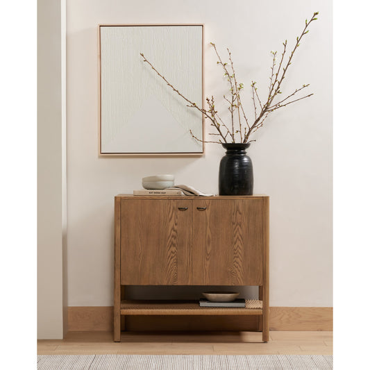 Zuma Cabinet by Four Hands in dune ash, gunmetal, natural paper cord and dune ash. Made from solid ash, rush in a cottage & farmhouse style.