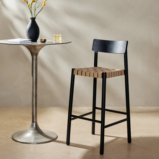 Heisler Bar Stool by Four Hands in black. Made from 70% split leather, 30% polyvinyl chloride (pvc), solid ash, ash veneer in a modern style.