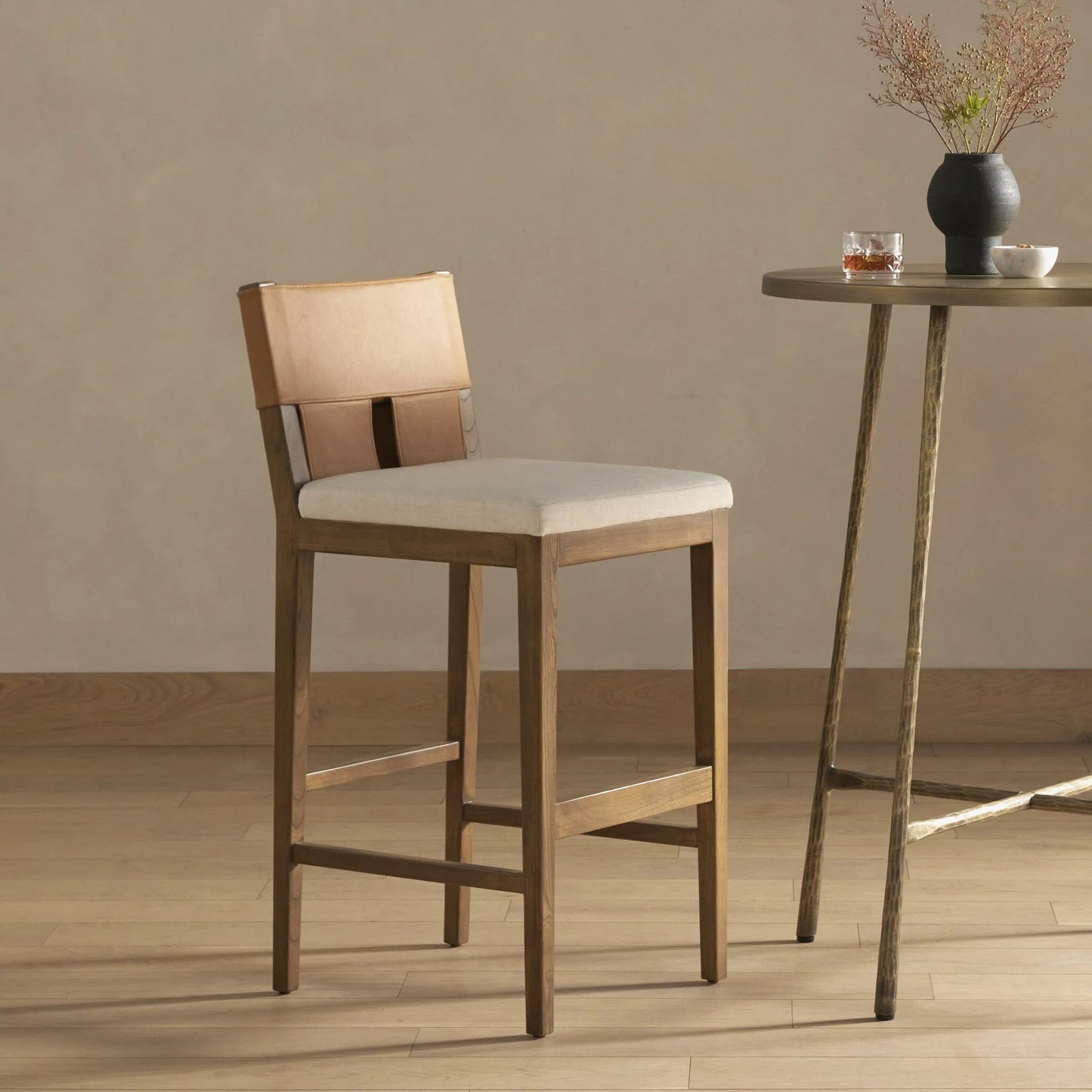 012 SI-1977782 | Lifestyle | Sem Counter Stool by Four Hands in palermo butterscotch, lamont nettlewood, halcyon ivory. Made from 92% polyester, 8% flax, linen, solid nettlewood, top grain leather in a modern style.