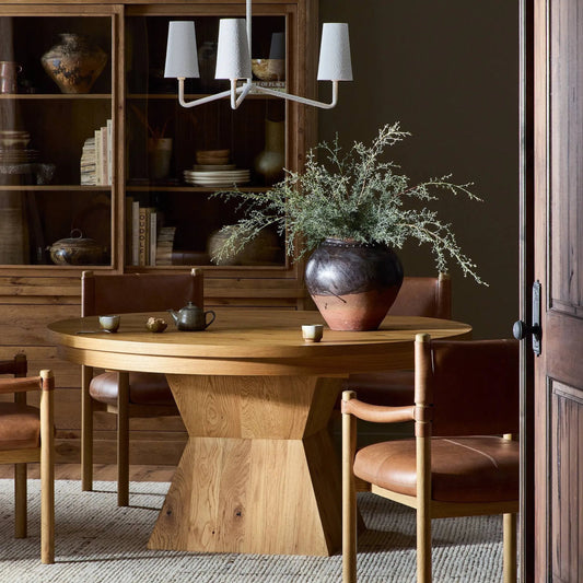 Leif Round Extension Dining Table by Four Hands in aged natural oak veneer. Made from thick oak veneer, solid oak in a transitional style.