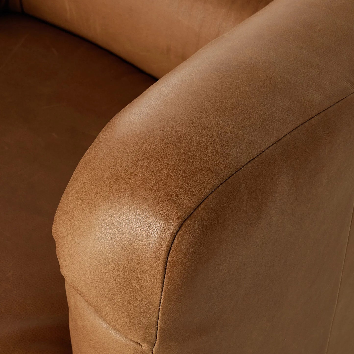007 SI-2320068 | Closeup | Gerrie Swivel Chair by Four Hands in brickhouse butterscotch. Made from top grain leather in a unique style.