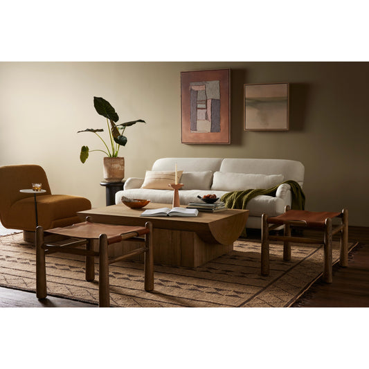 Nino Ottoman by Four Hands in dakota tobacco. Made from top grain leather, solid nettlewood, 100% polyester in a modern style.