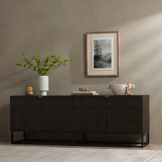Kelby Closed Media Console by Four Hands in aged brass, carved vintage brown, vintage brown, gunmetal. Made from solid mango, iron in a modern style.