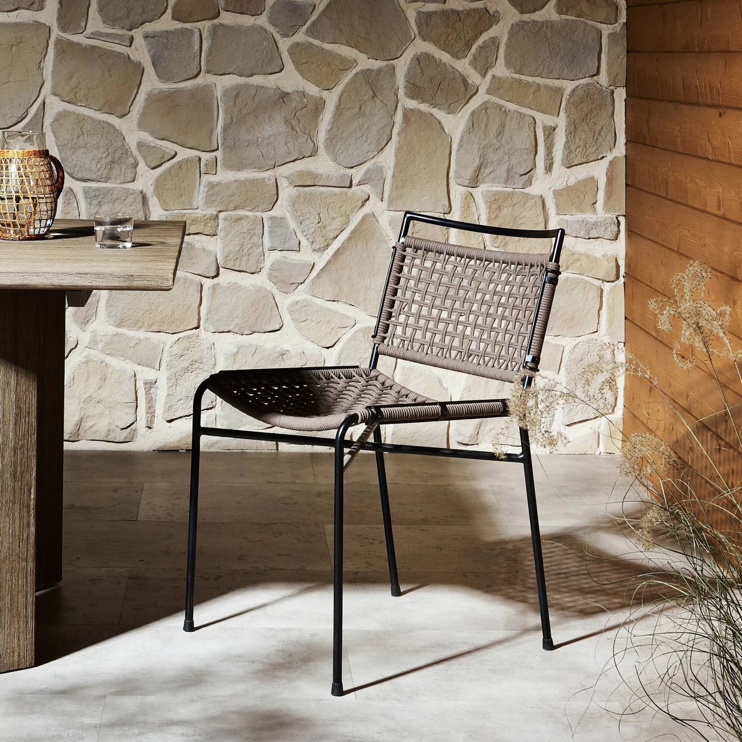 021 SI-2137718 | Lifestyle | Wharton Outdoor Dining Chair by Four Hands in earth rope and satin black. Made from iron, 100% polyester in a modern style.