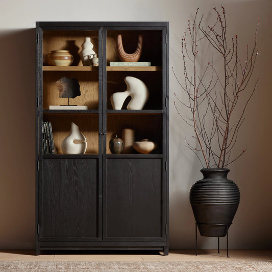 Millie Panel & Glass Door Cabinet by Four Hands in drifted matte black. Made from solid oak, oak veneer in a modern style.
