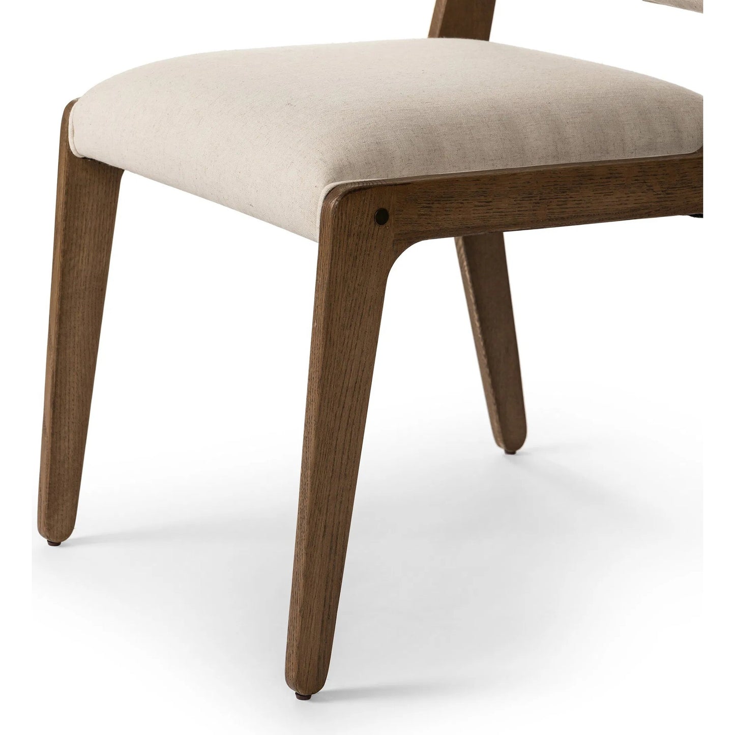 008 SI-2320196 | Closeup | Norwalk Dining Chair by Four Hands in savile flax, lamont oak, antique brass. Made from 92% polyester, 8% flax/linen, solid oak, stainless steel in a unique style.