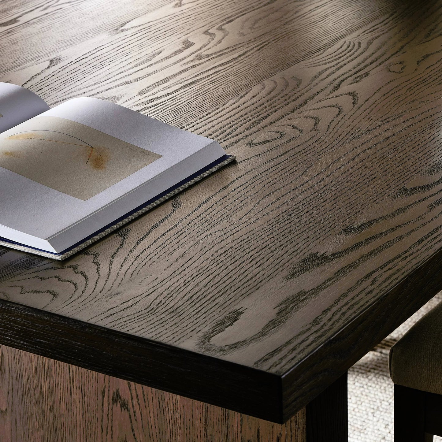 012 SI-2158554 | Closeup | Torrington Dining Table by Four Hands in umber oak, umber oak veneer and umber oak. Made from resawn oak, oak veneer, engineered hardwood in a modern style.