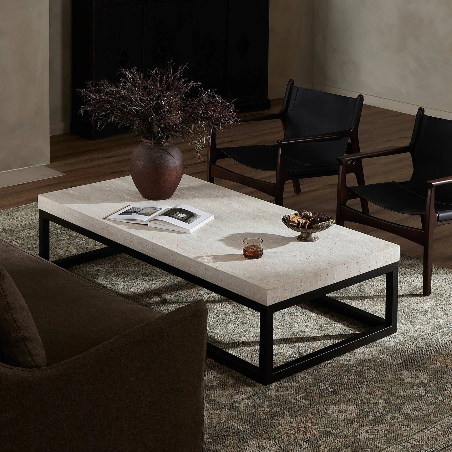 012 SI-2137646 | Lifestyle | The Rectangular Coffee Table by Four Hands in travertine, bronze pebble texture. Made from solid travertine, iron in a modern style.
