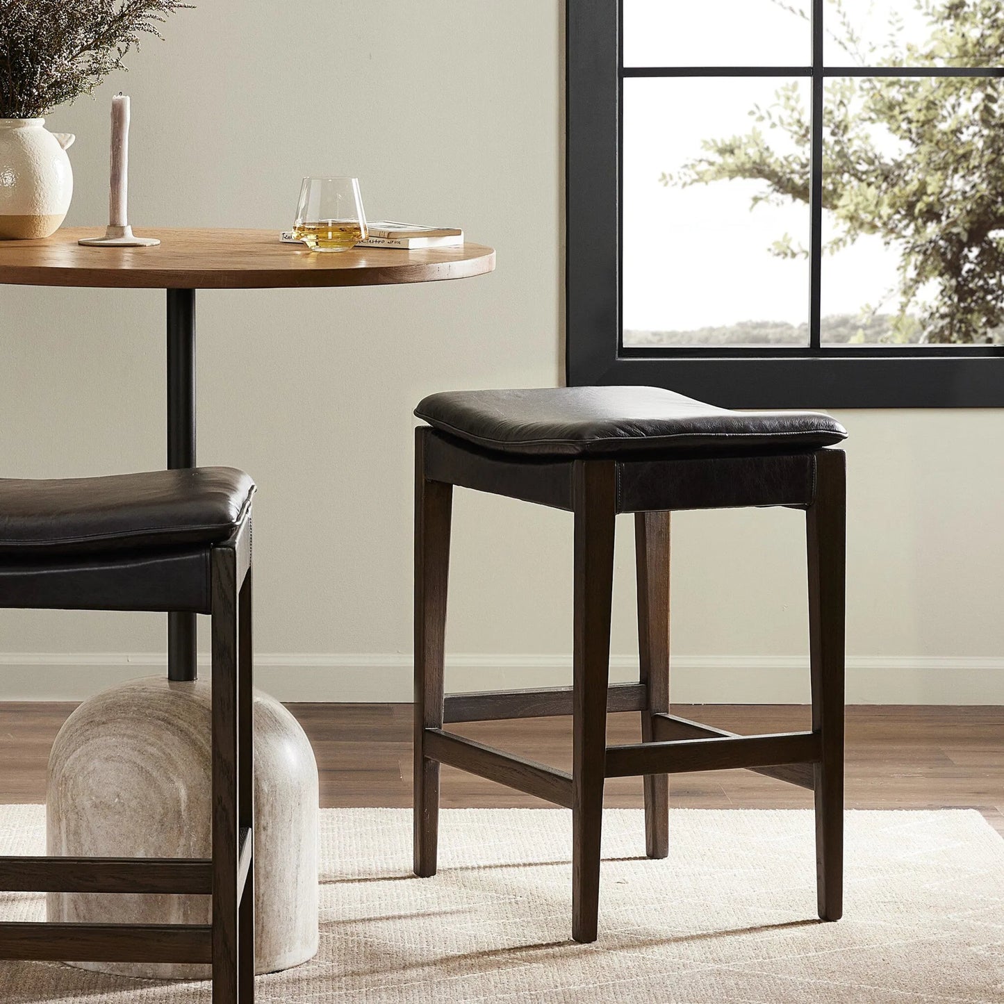 017 SI-2137190 | Lifestyle | Aya Bar Stool by Four Hands in sonoma black and burnt oak. Made from top grain leather, solid oak, 100% polyester in a modern style.
