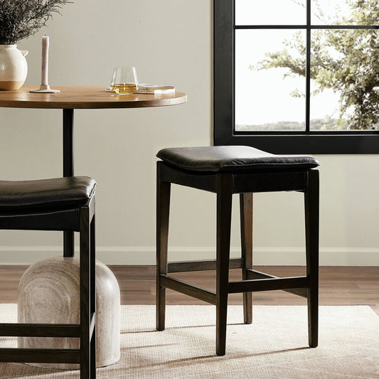 Aya Counter Stool by Four Hands in sonoma black and burnt oak. Made from top grain leather, solid oak, 100% polyester in a modern style.