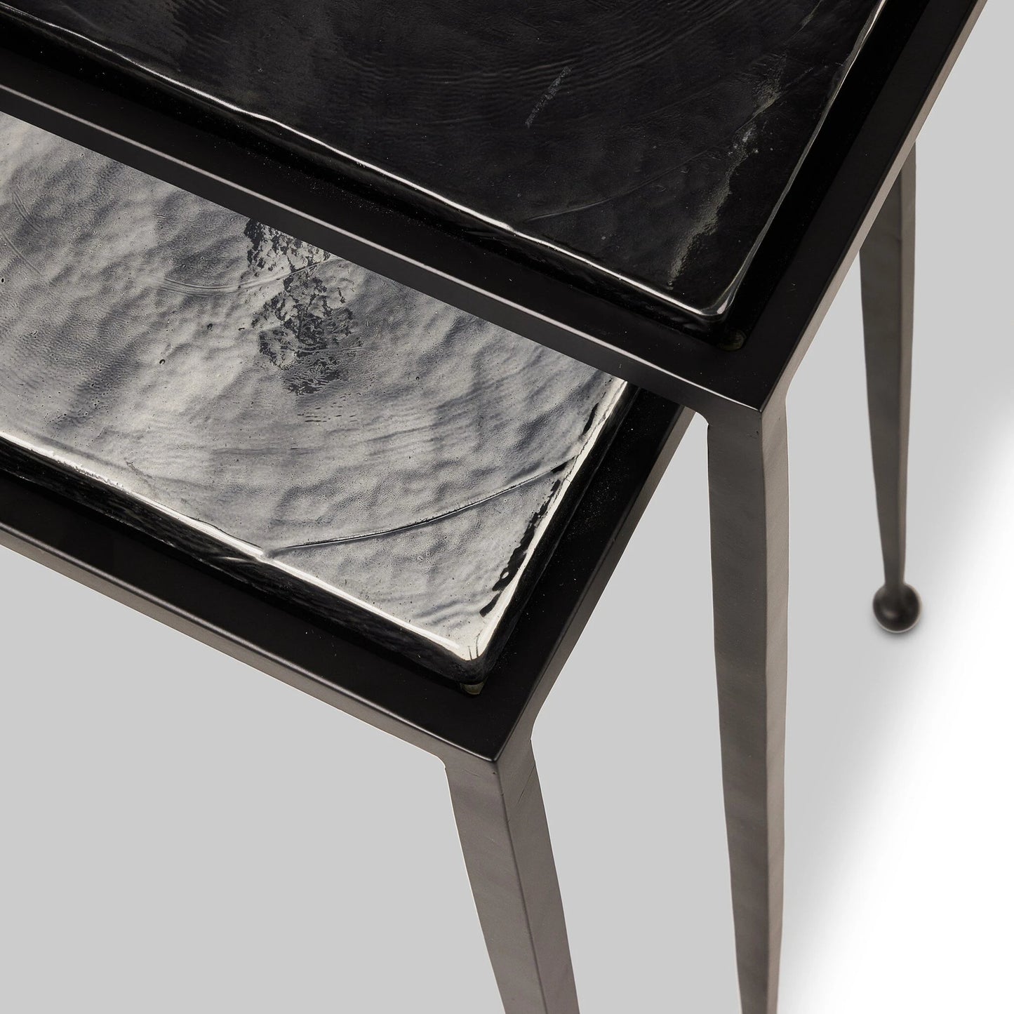 002 SI-2137287 | Closeup | Dalston Cast Glass Nesting Tables by Four Hands in smoked black cast glass, iron matte black. Made from cast glass, iron in a modern style.
