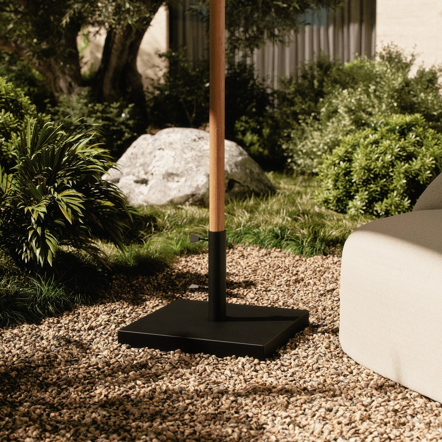 009 SI-2158058 | Lifestyle | Baska Outdoor Umbrella Stand by Four Hands in black stainless steel. Made from stainless steel in a modern style.