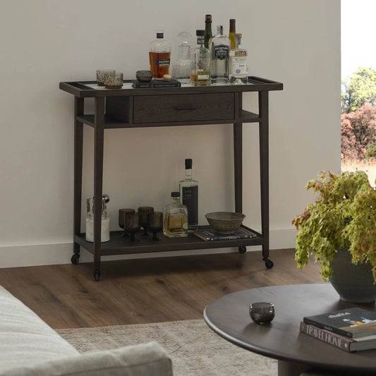 Dorrit Bar Cart by Four Hands in brown oak, honed white marble, smooth black metal. Made from solid oak, solid marble, aluminum in a transitional style.