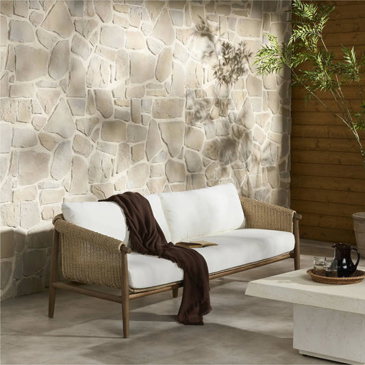 Cambrie Outdoor Sofa by Four Hands in arashi salt, stained toasted brown, faux hyacinth. Made from 100% acrylic, solid teak, 100% polyethylene in a rustic style.