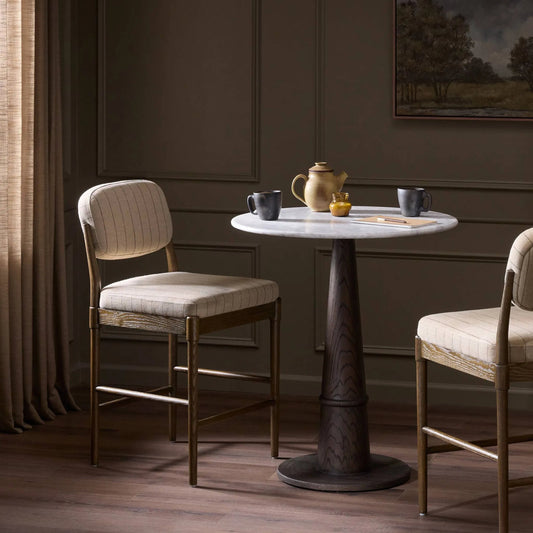 Esther Bar Stool by Four Hands in lavon flint, drifted oak. Made from 80% linen; 20% cotton, solid oak in a transitional style.