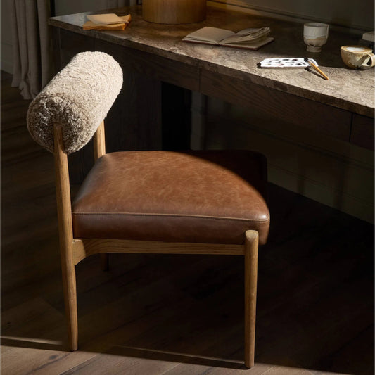 Jazelle Dining Chair by Four Hands in havana brown, tan oak, taupe shearling. Made from top grain leather, solid oak, shearling in a traditional style.