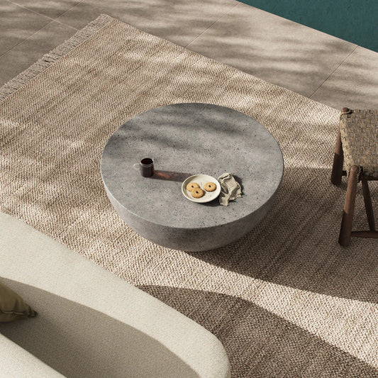 Boula Outdoor Coffee Table by Four Hands in aged smoke concrete. Made from solid concrete in a transitional style.