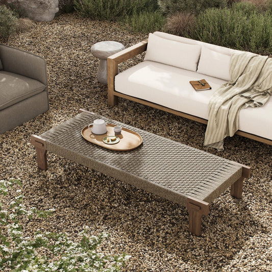Moxie Outdoor Coffee Table by Four Hands in stained toasted brown-fsc, dark textured woven. Made from solid fsc®-certified teak, 100% polyethylene in a transitional style.