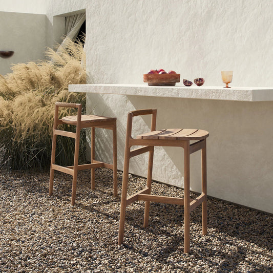 Baden Outdoor Bar Stool by Four Hands in textured sand, fine sanded teak-fsc. Made from 100% polyethylene, solid fsc®-certified teak in a transitional style.