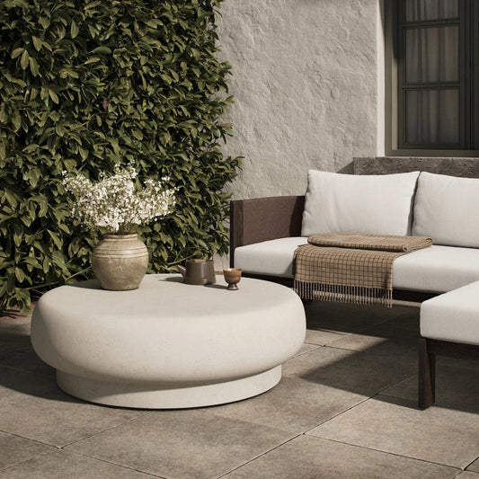 Imogene Round Outdoor Coffee Table by Four Hands in aged white concrete. Made from solid concrete in a unique style.
