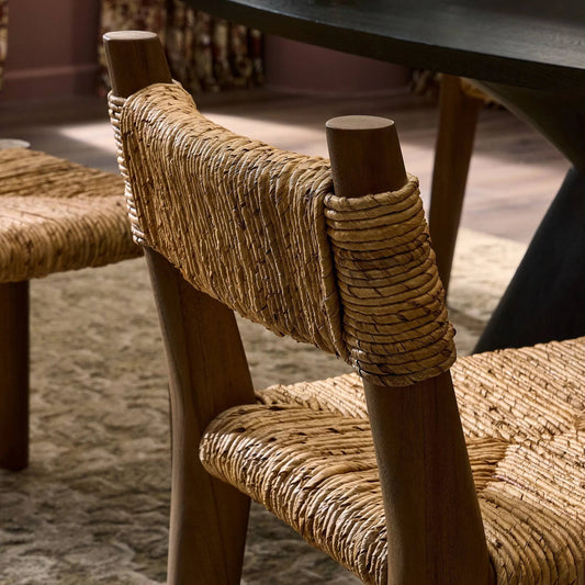 Bovard Dining Chair by Four Hands in stained toasted brown, slight dark bleaching. Made from solid teak, banana leaf in a rustic style.