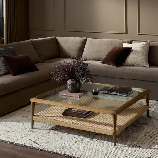 Carmelo Coffee Table by Four Hands in tempered glass, natural paper cord, medium brown oak. Made from tempered glass, rush, solid oak in a transitional style.
