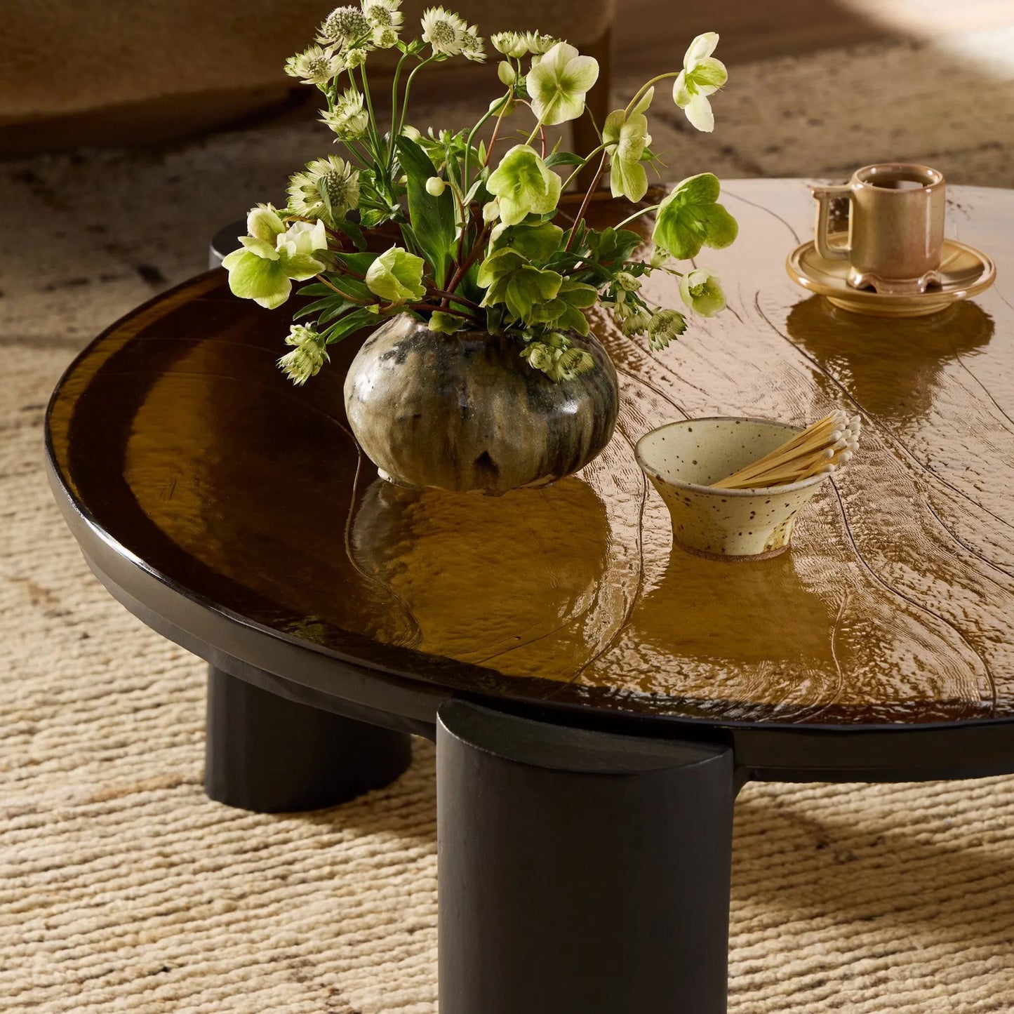 023 SI-2531688 | Closeup | Rover Nesting Table by Four Hands in amber cast glass, black antique. Made from cast glass, aluminum in a unique style.
