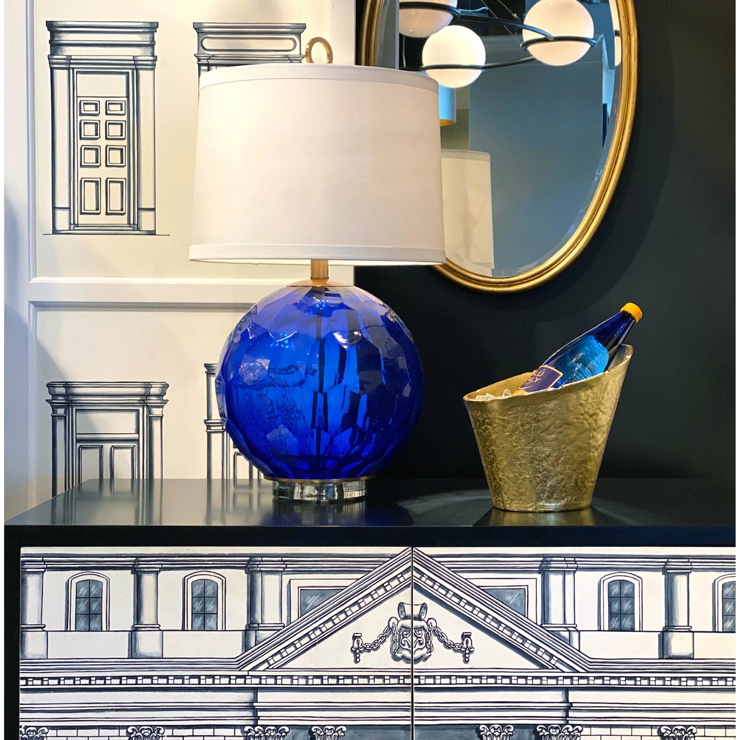 003 SR-384589 | Lifestyle | Tobago Oval Gold Wall Mirror by Wildwood in antique gold leaf, beveled, clear. Made from iron in a transitional style.