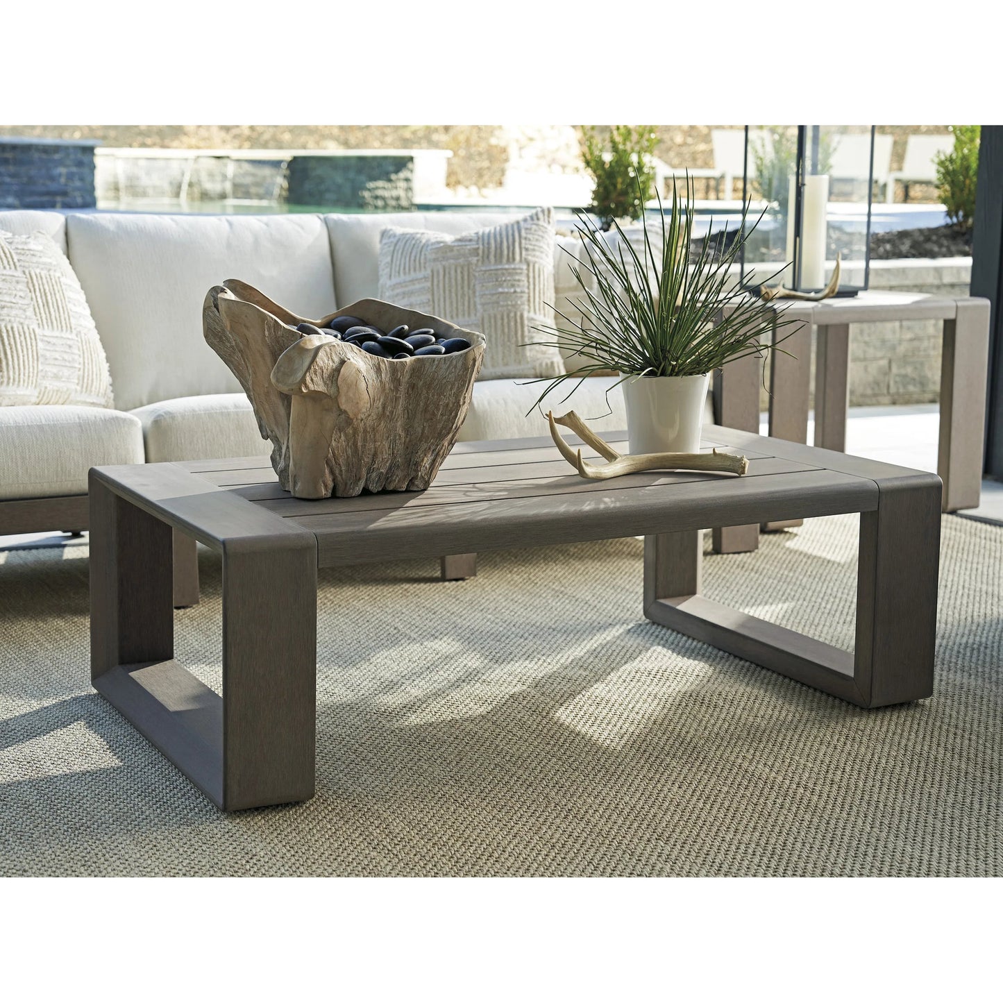 004 SI-2242648 | Lifestyle | Mozambique Rectangular Cocktail Table by Tommy Bahama Outdoor in taupe gray. Made from unique in a transitional style.