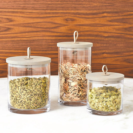 Rustic Canister by Global Views. Made from oak, glass, leather in a transitional style.