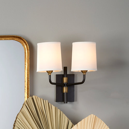 Lawton Double Arm Wall Sconce by Jamie Young in antique brass. Made from metal in a traditional style.