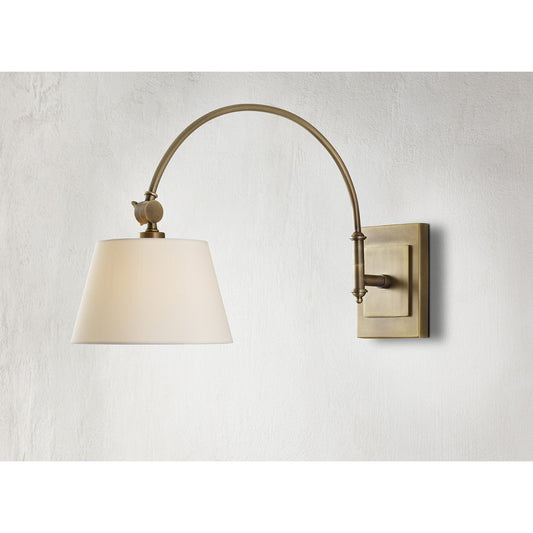 Ashby Swing-Arm Sconce by Currey and Company in antique brass. Made from brass in a traditional style.