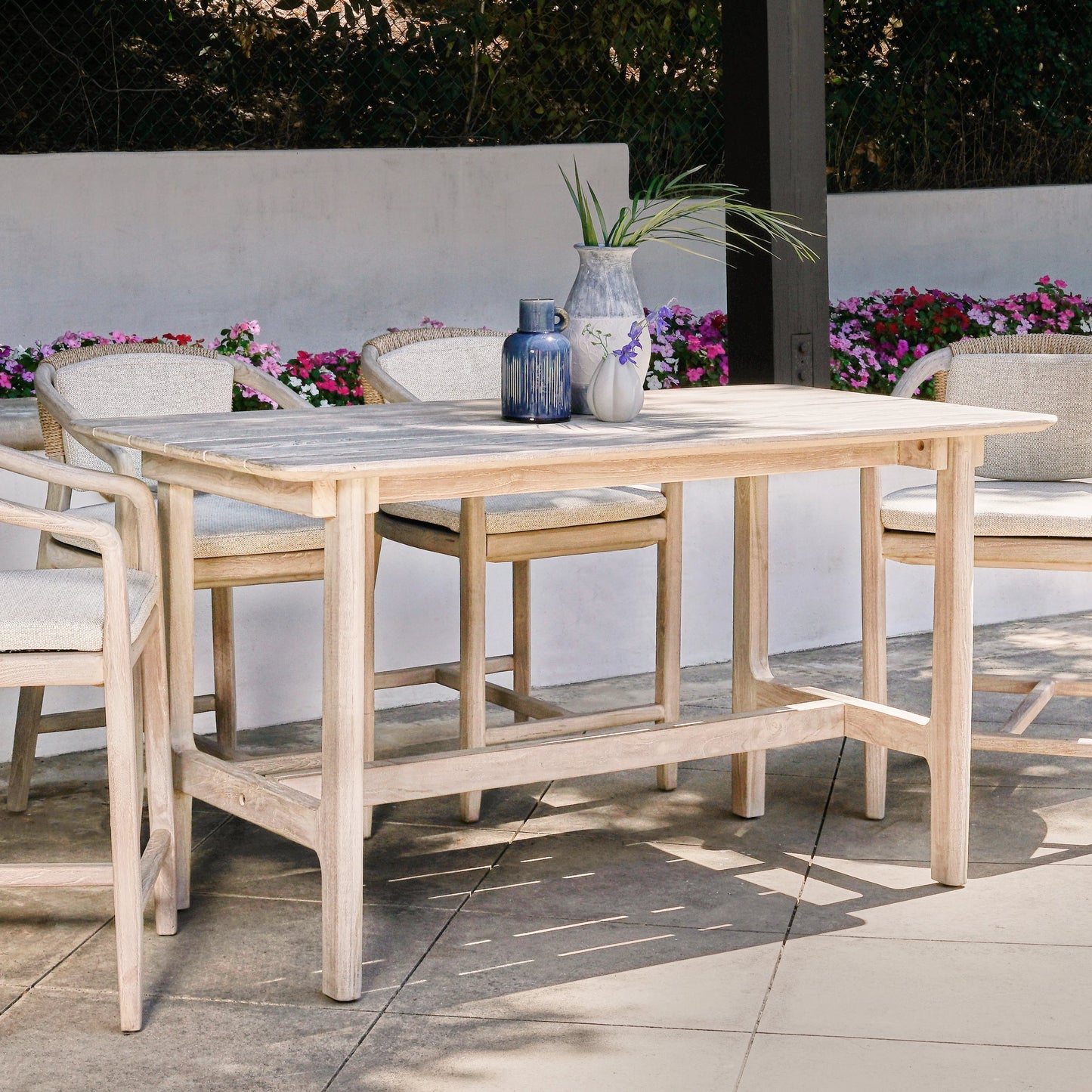 015 SI-2078716 | Lifestyle | Dawn Outdoor Counter Table by Classic Home in gray matte. Made from teak wood in a modern style.