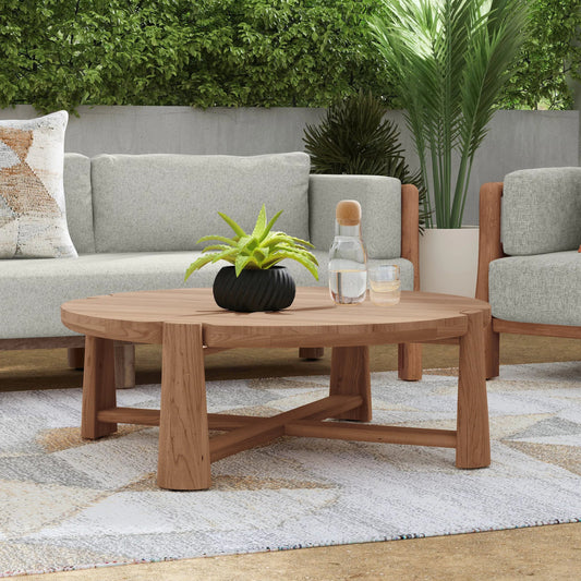 Aston 48" Round Teak Outdoor Coffee Table by Classic Home in natural. Made from teak wood in a transitional style.