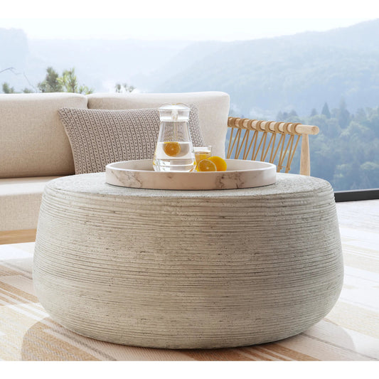 Nellie Round Outdoor Coffee Table by Classic Home in rough light grey. Made from concrete in a modern style.