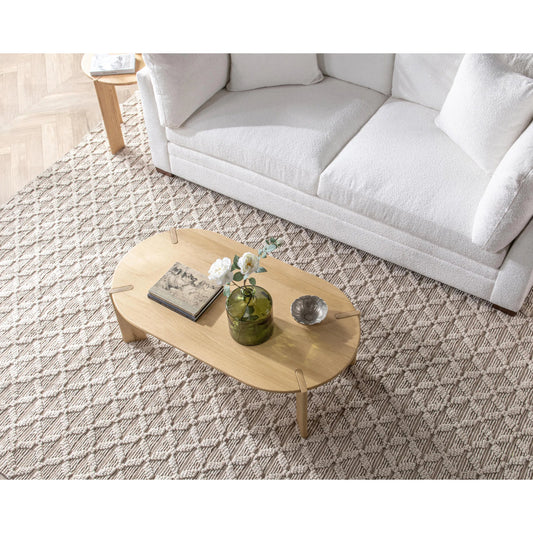 Kering Oak Wood Oval Coffee Table by Kosas Home in natural. Made from solid oak wood in a transitional style.