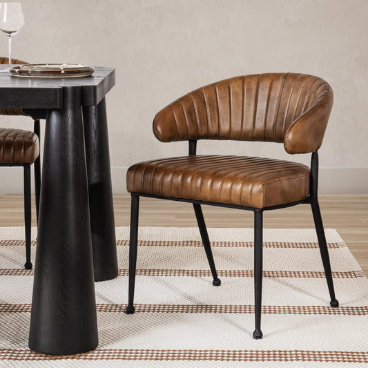 Umbria Dining Chair by Classic Home. Made from top grain leather, iron in a transitional style.