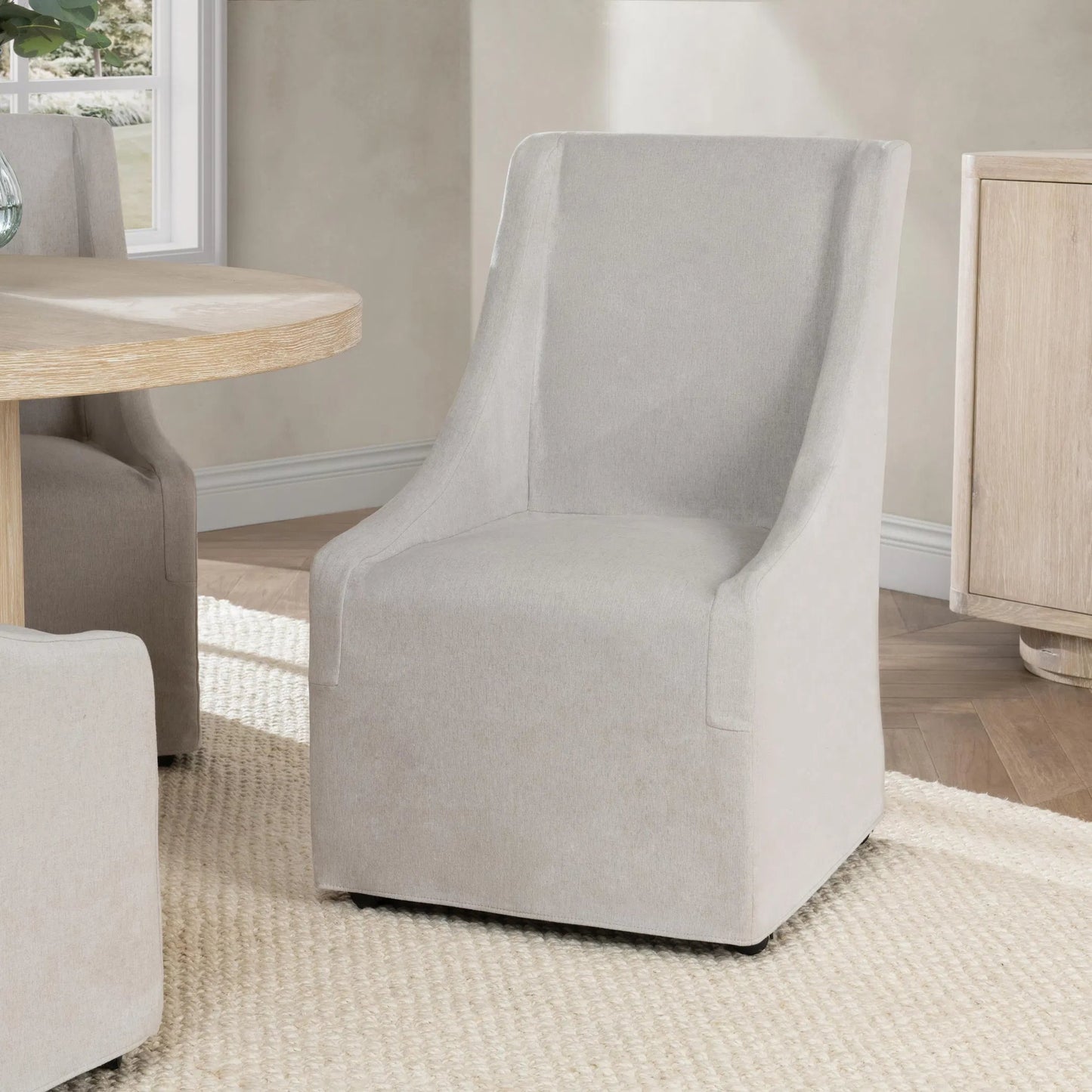 002 SI-2303344 | Lifestyle | Warwick Upholstered Rolling Dining Chair by Classic Home. Made from 100% polyester in a transitional style.