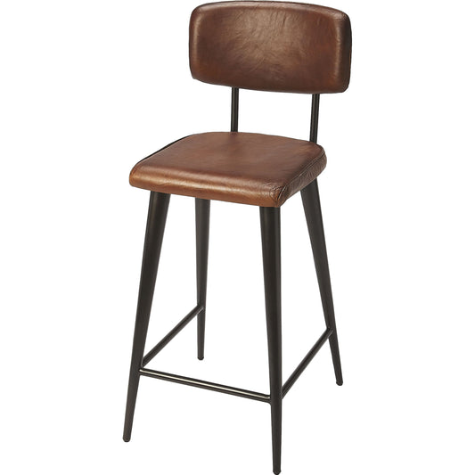 Saddle Counter Stool by Butler Specialty Company in dark brown and brown leather. Made from iron, leather, plywood, tris free fr foam in a rustic style.